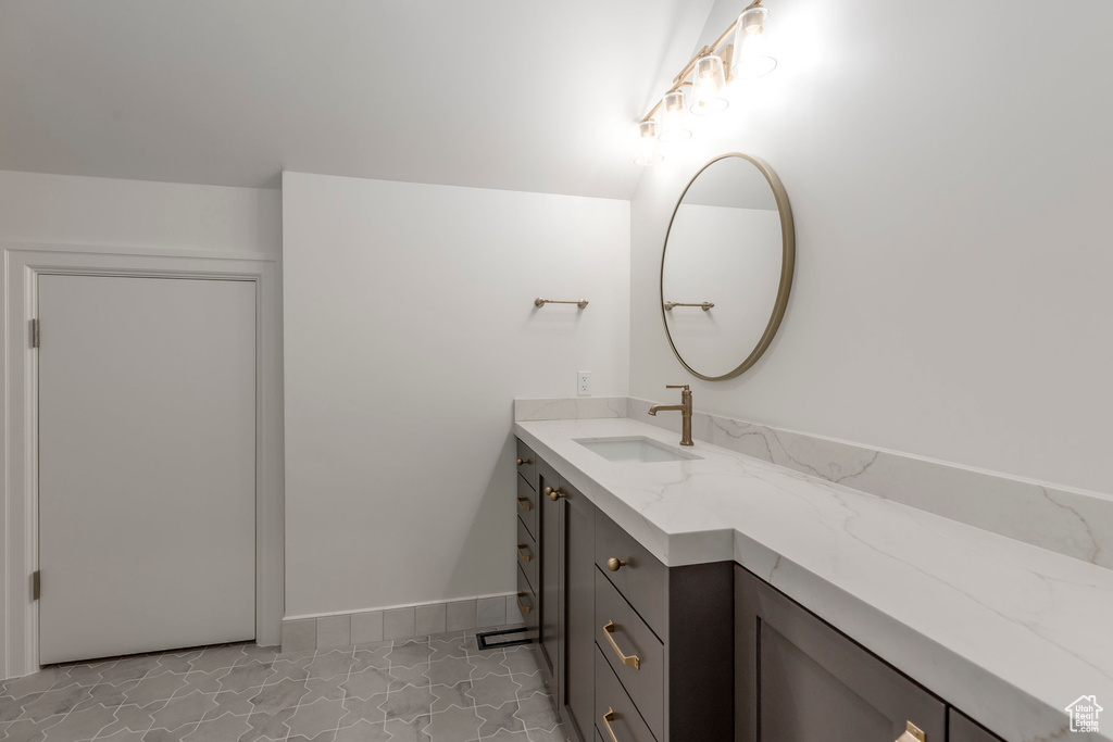 Bathroom featuring vanity and baseboards