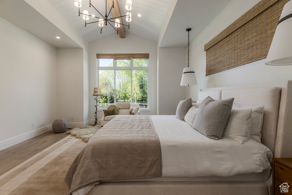 Bedroom with a chandelier, wood finished floors, baseboards, and recessed lighting