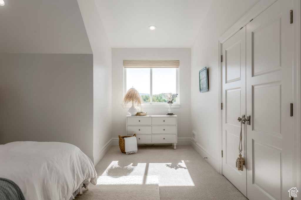 Bedroom with light colored carpet, baseboards, and recessed lighting