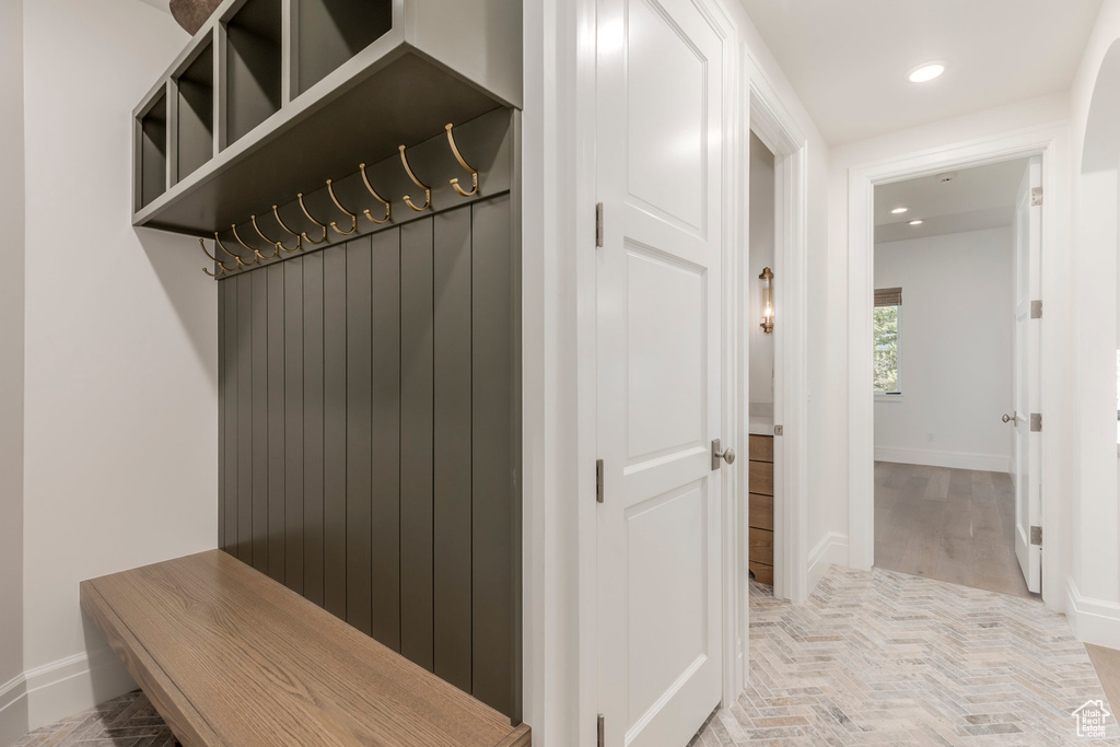 Mudroom with recessed lighting and baseboards