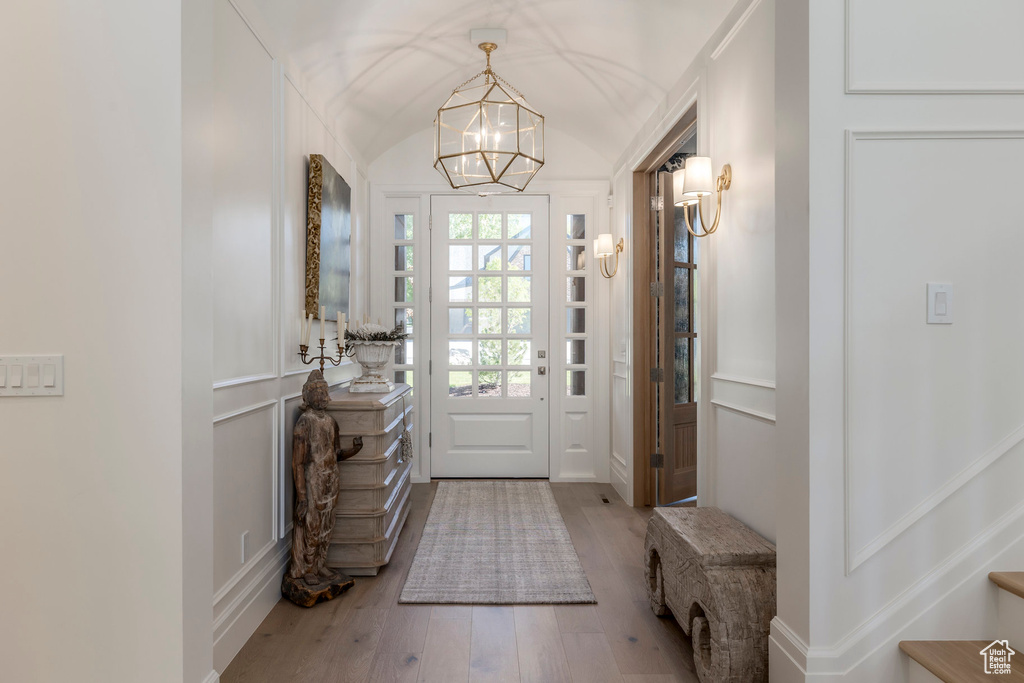 Entryway featuring hardwood / wood-style floors and a chandelier