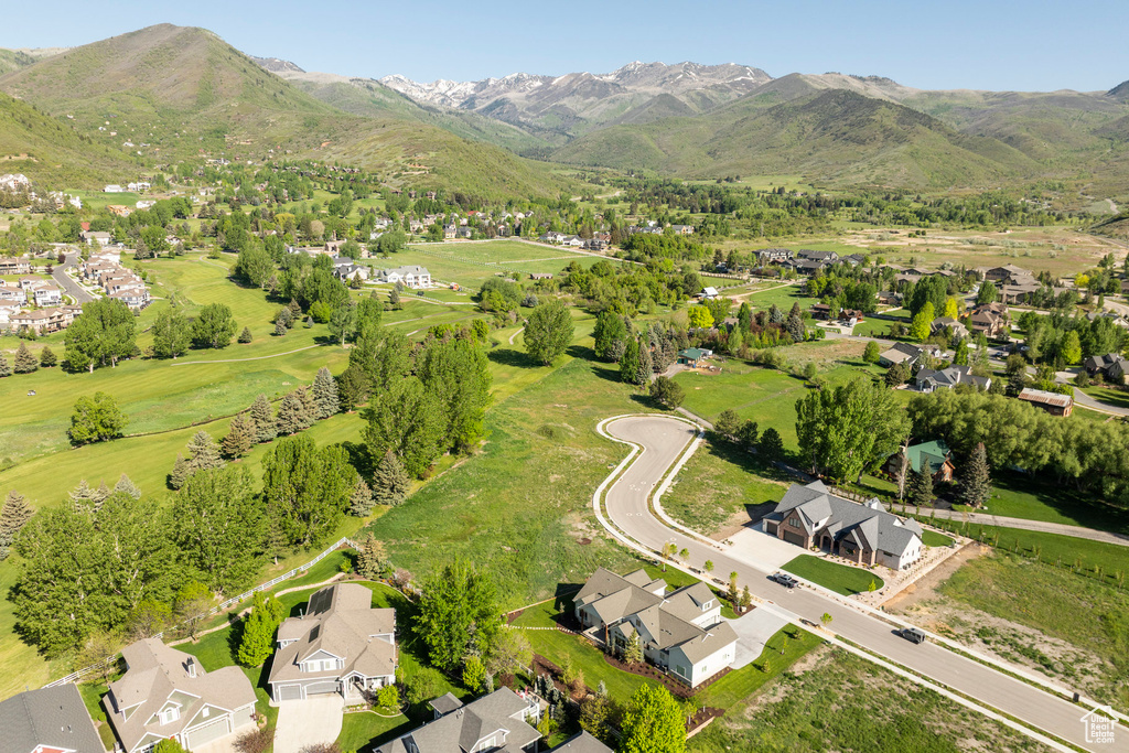 Aerial view of residential area featuring mountains and a golf course