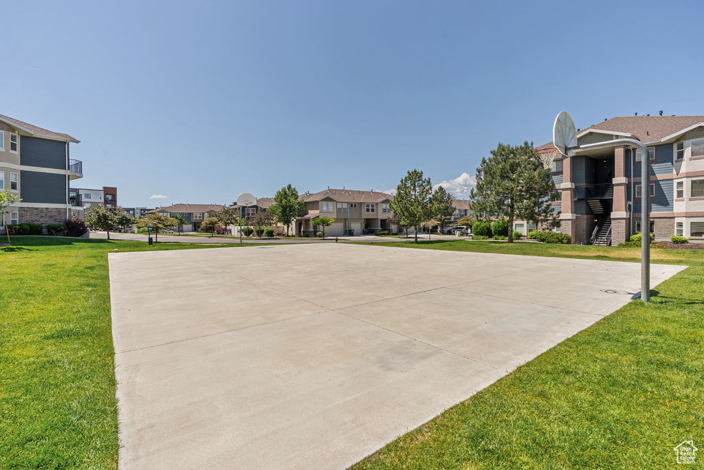 View of basketball court featuring community basketball court, a residential view, and a lawn
