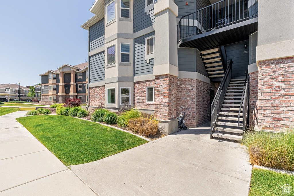 View of property with stairs and a residential view