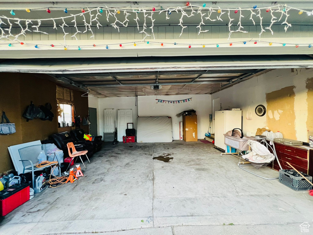 Garage featuring freestanding refrigerator