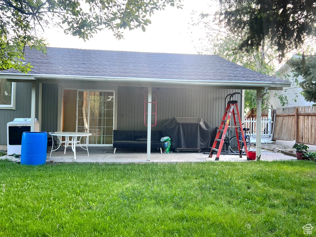 Back of house with a patio area, cooling unit, and roof with shingles