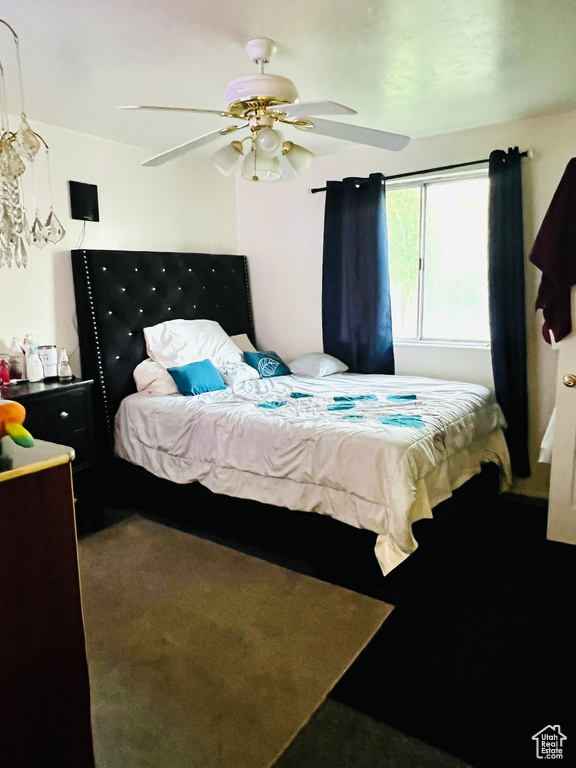 Carpeted bedroom with ceiling fan