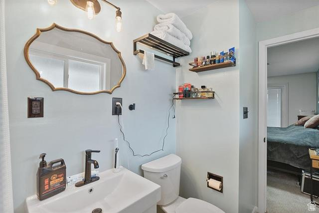 Bathroom featuring a sink, toilet, and ensuite bath