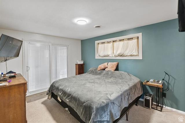 Bedroom featuring carpet floors and baseboards