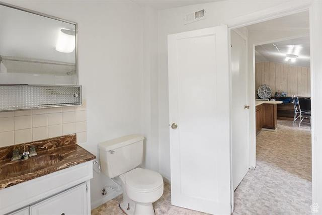Bathroom featuring vanity and toilet