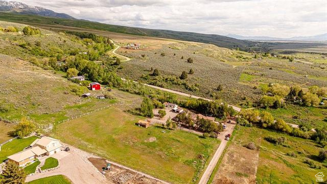 Aerial view of property's location with a mountainous background and rural landscape