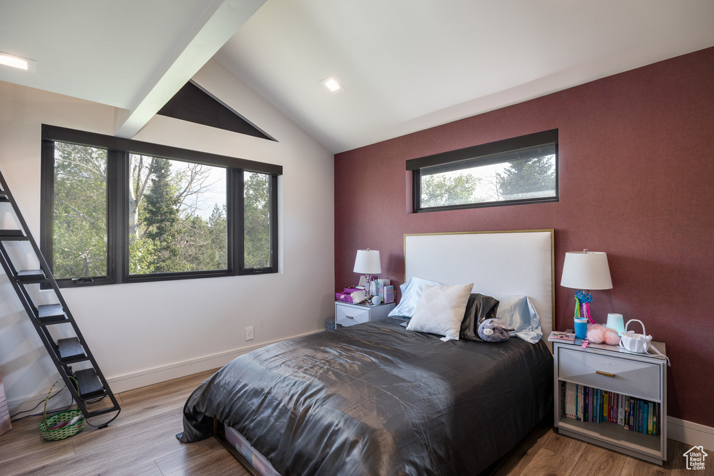 Bedroom featuring wood finished floors and baseboards