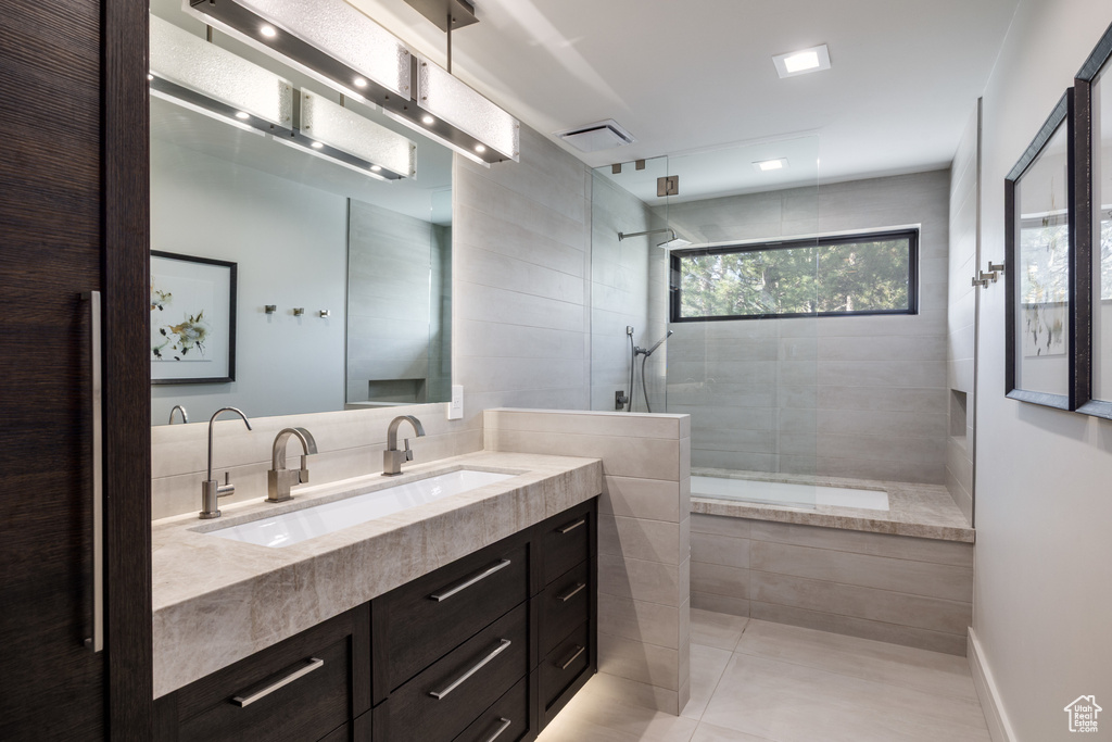 Bathroom with vanity, tile patterned flooring, and walk in shower