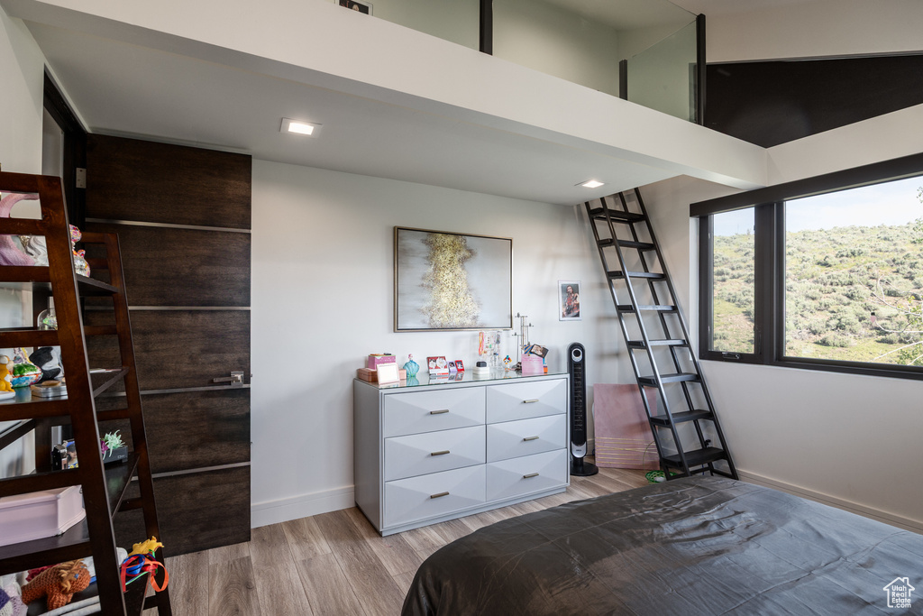 Bedroom with light wood-style floors and baseboards