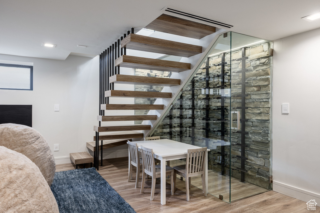 Wine area with baseboards and wood finished floors