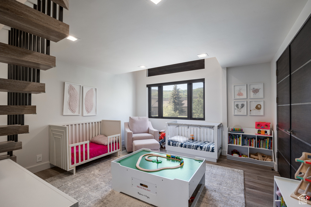 Bedroom featuring wood finished floors and baseboards