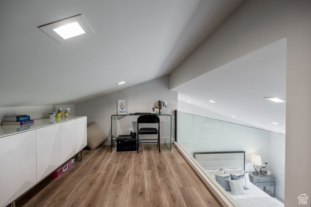 Additional living space featuring lofted ceiling, light wood finished floors, and recessed lighting