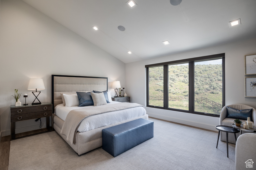 Bedroom featuring lofted ceiling, baseboards, light wood-style floors, and recessed lighting
