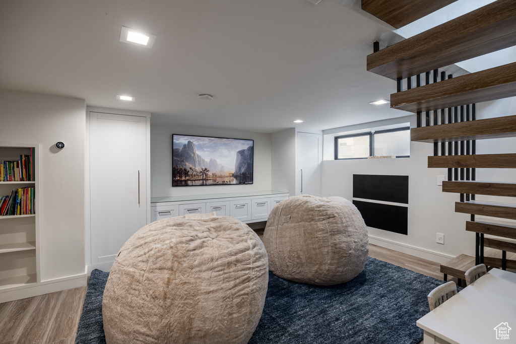 Living area featuring light wood-style floors, recessed lighting, and baseboards