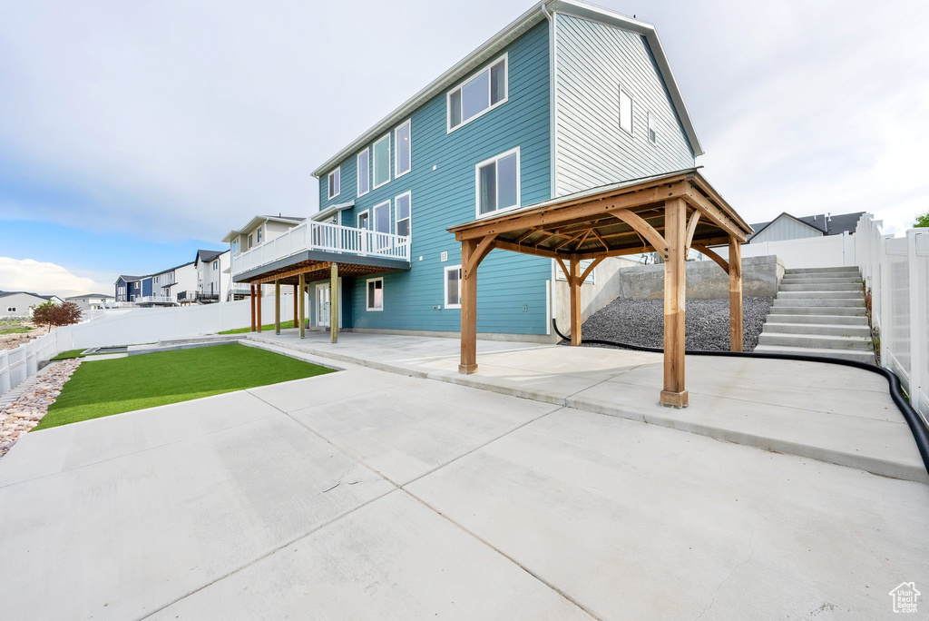 Back of property with a patio and a gazebo