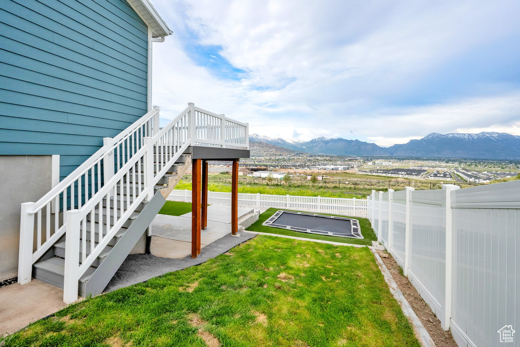 View of yard featuring stairway, a mountain view, and a patio area