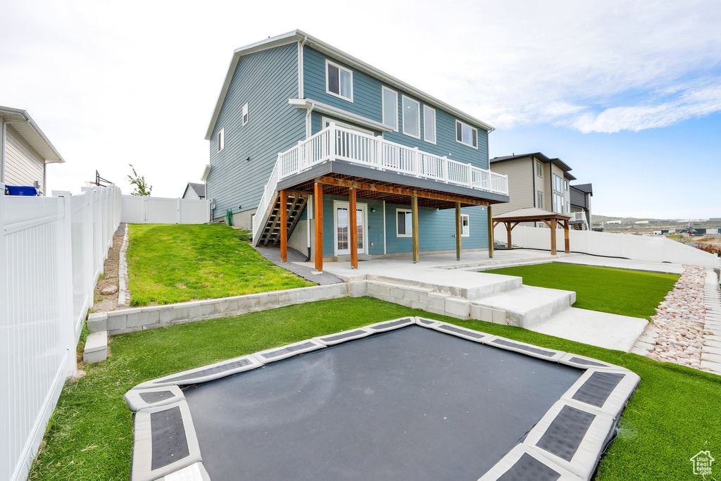 Back of house with a gazebo, a wooden deck, a patio area, and stairway