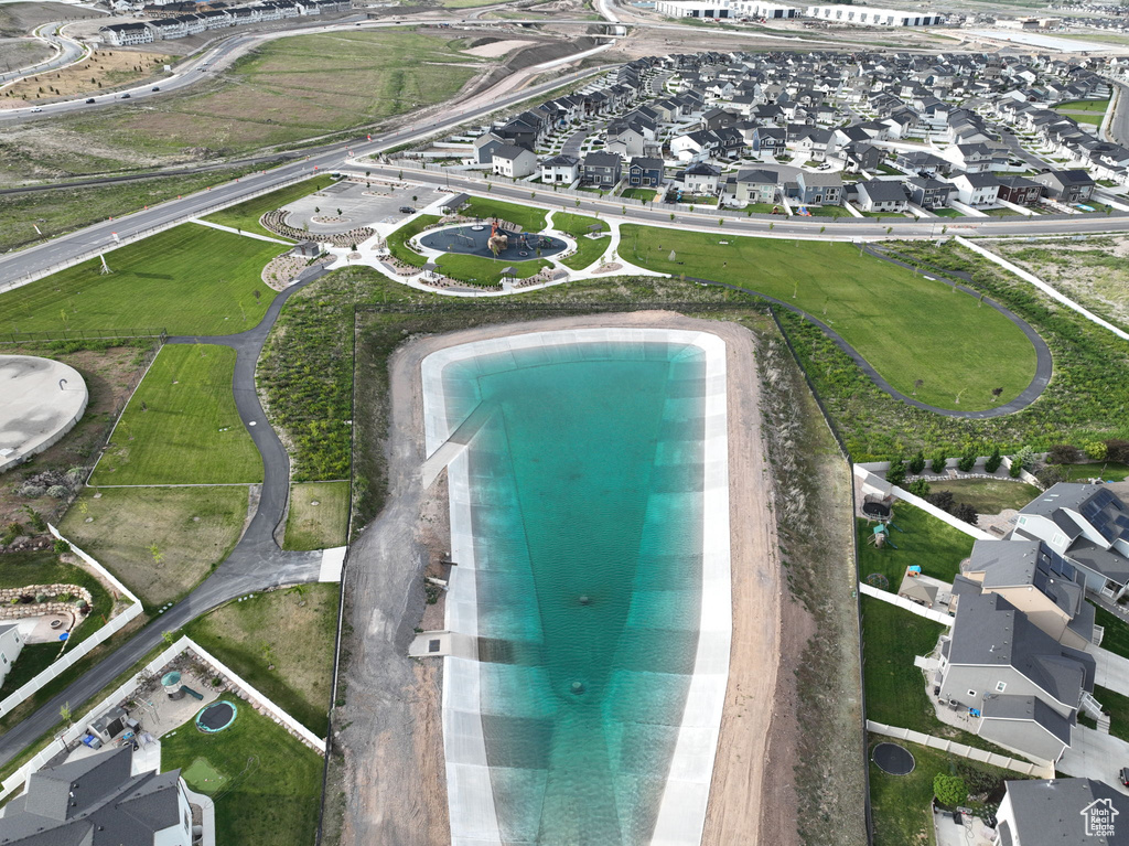 Aerial view of property and surrounding area featuring nearby suburban area