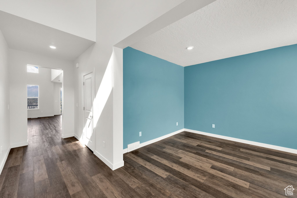 Additional living space with wood finished floors, baseboards, and recessed lighting