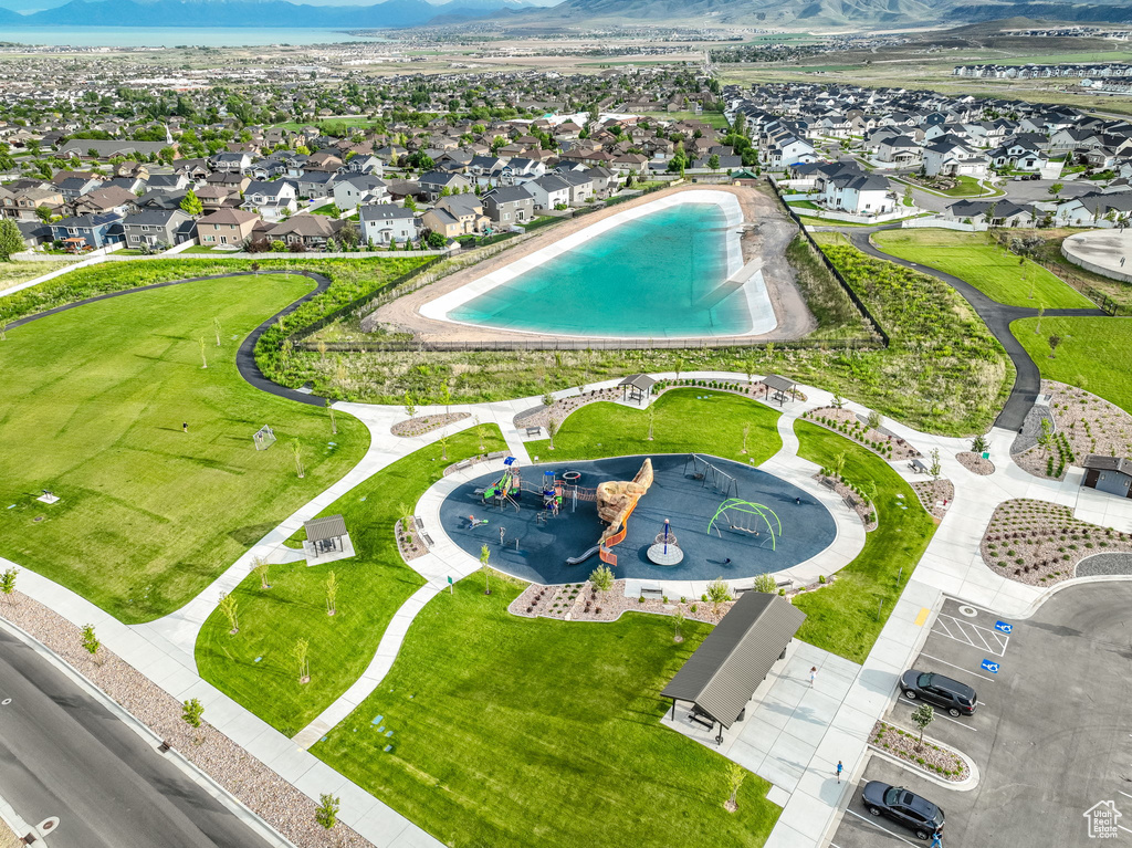 Aerial view of residential area with a mountain backdrop and a pool