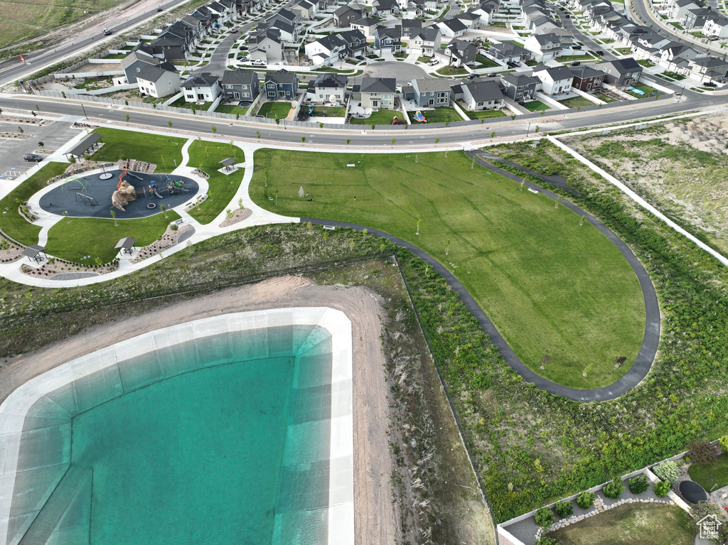 Aerial view of property\'s location featuring a pool and nearby suburban area