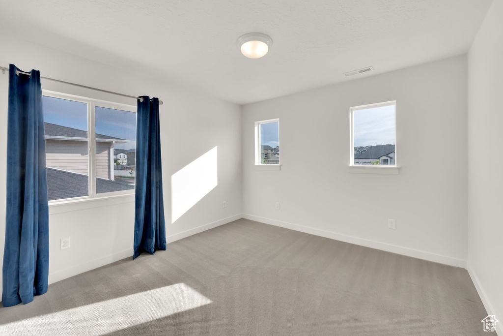 Carpeted empty room with baseboards