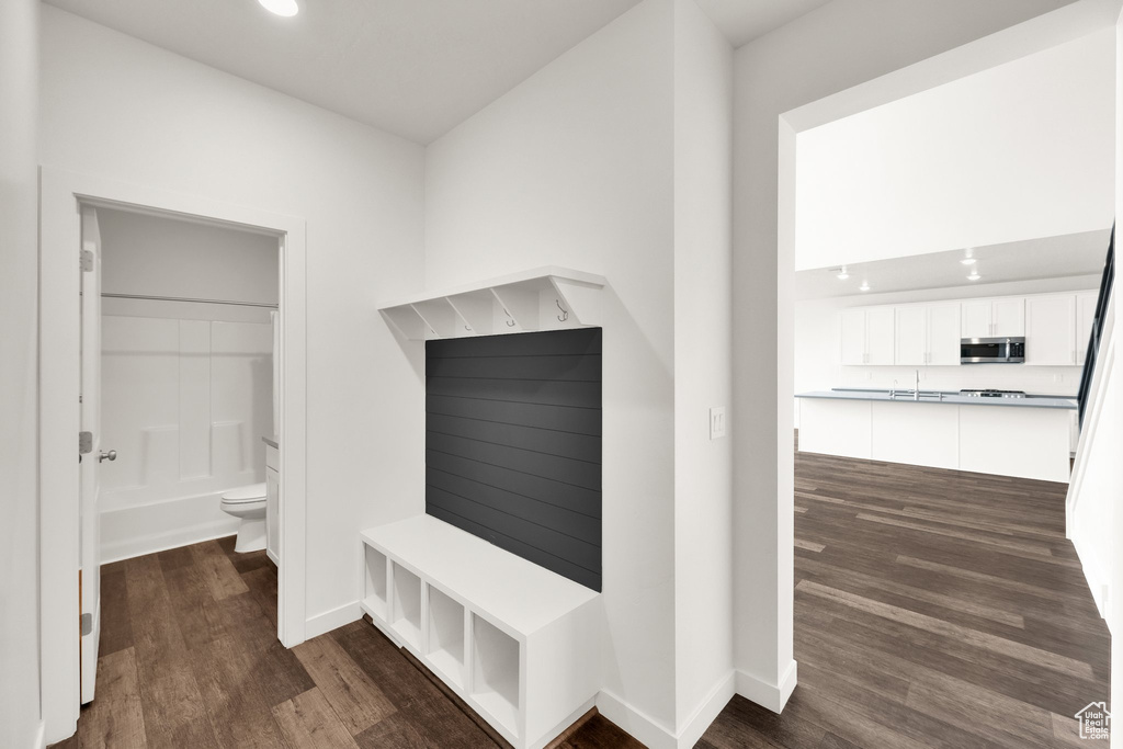 Mudroom featuring dark wood finished floors, baseboards, and recessed lighting