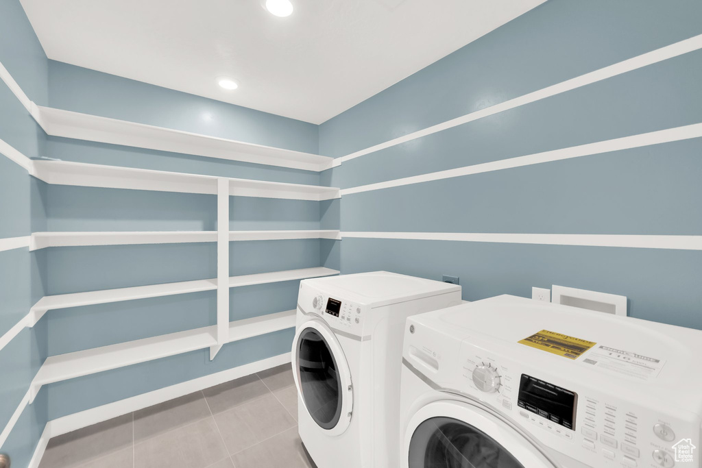 Laundry area with washing machine and dryer, tile patterned flooring, recessed lighting, and baseboards