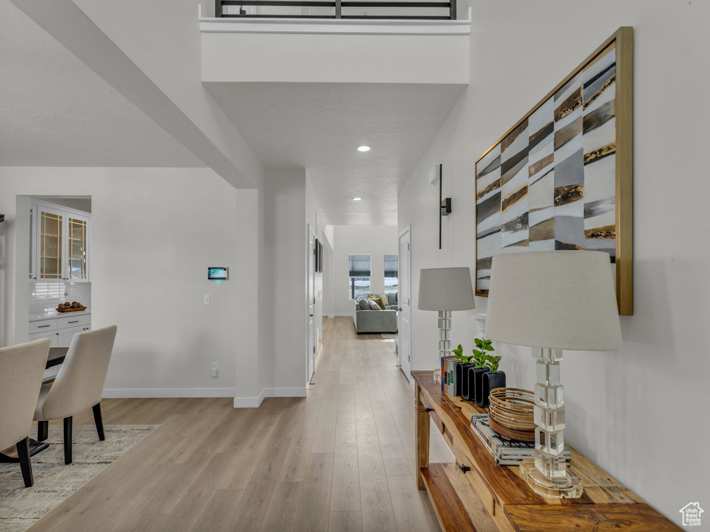 Corridor featuring light wood finished floors, baseboards, and recessed lighting