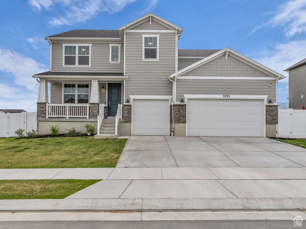 Craftsman house with driveway, a gate, a porch, and stone siding