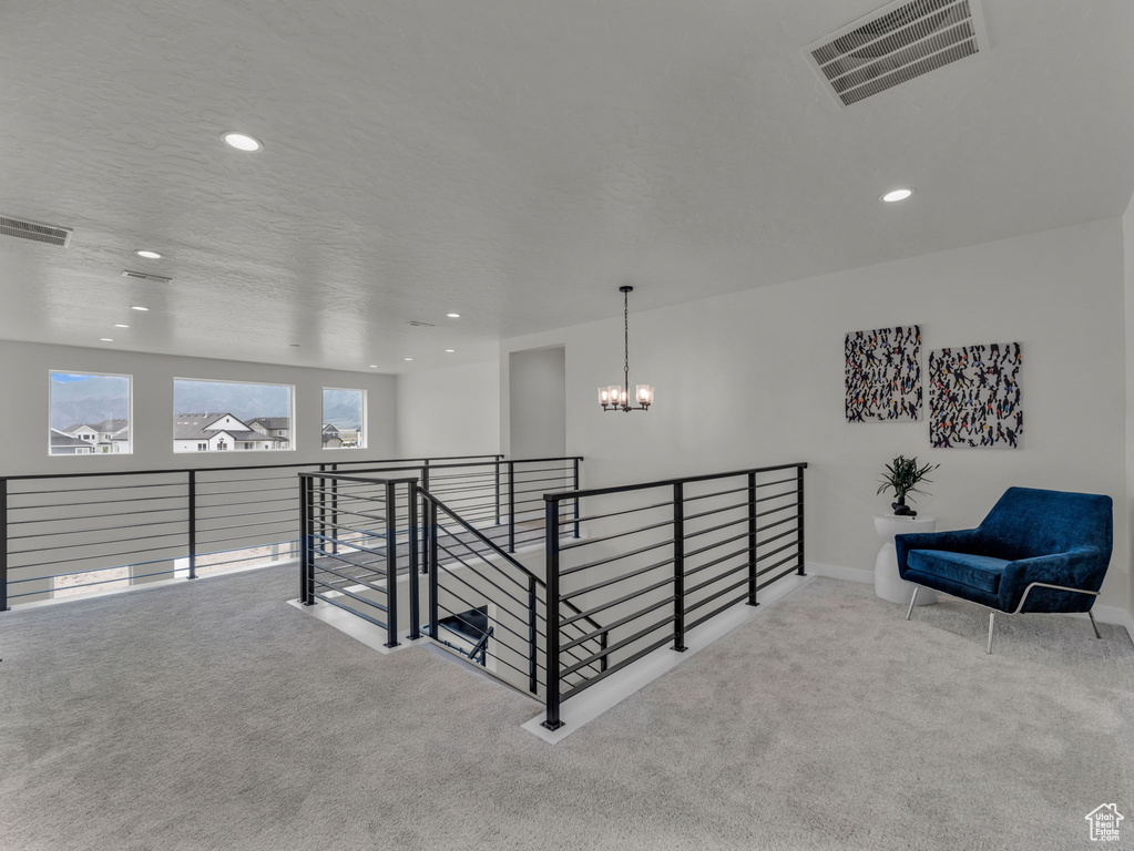 Corridor featuring carpet flooring, a chandelier, recessed lighting, an upstairs landing, and baseboards