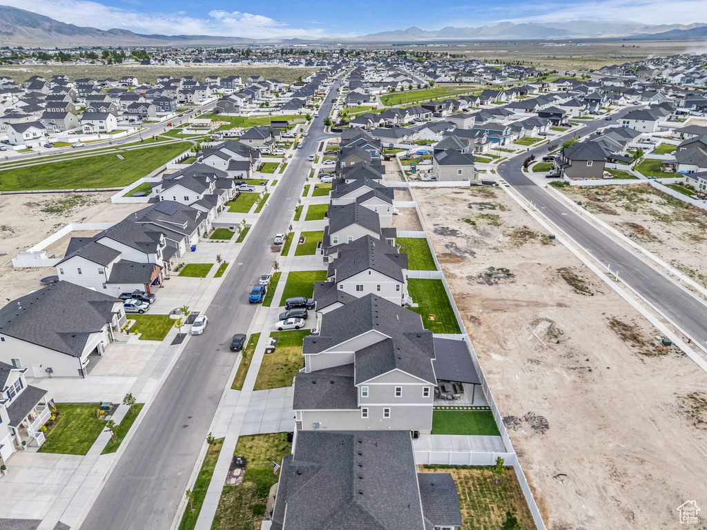 Aerial view of property's location featuring nearby suburban area and a mountainous background
