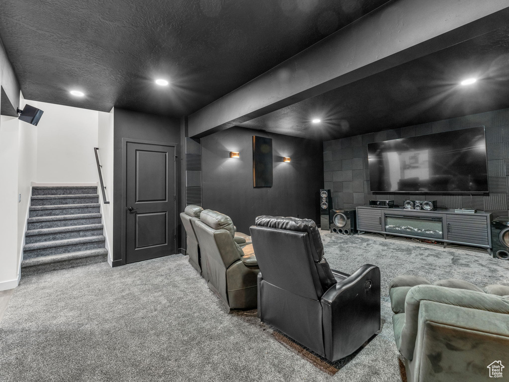 Cinema room with carpet, recessed lighting, baseboards, and a textured ceiling