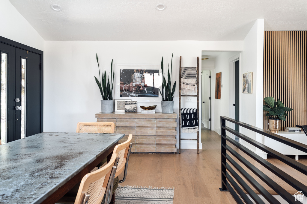 Dining area with light wood-style flooring and recessed lighting