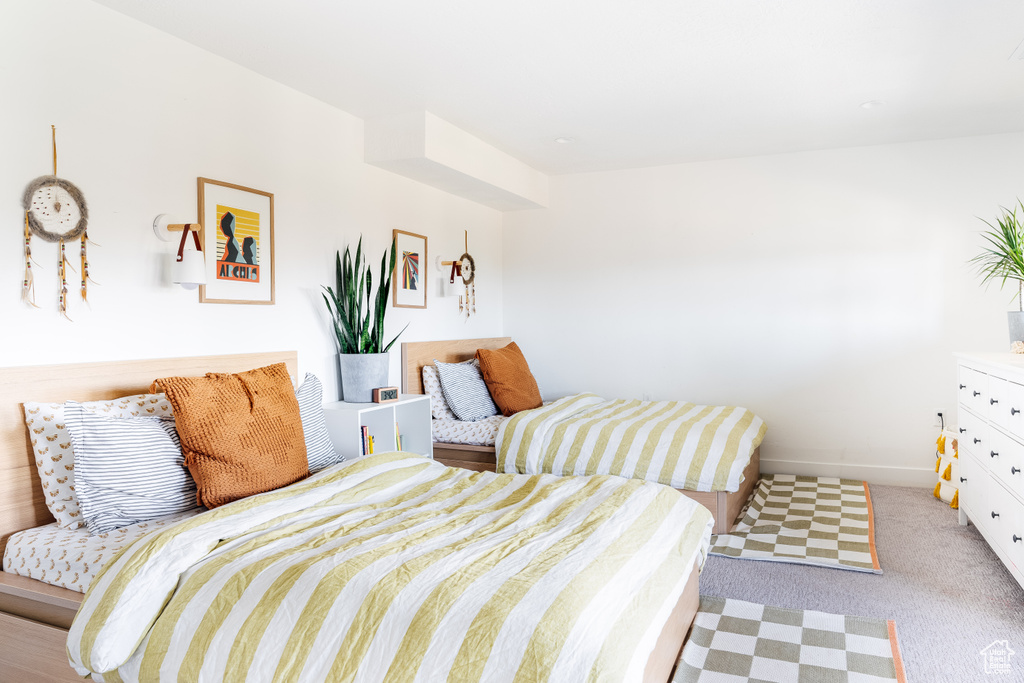 Bedroom featuring baseboards and light colored carpet
