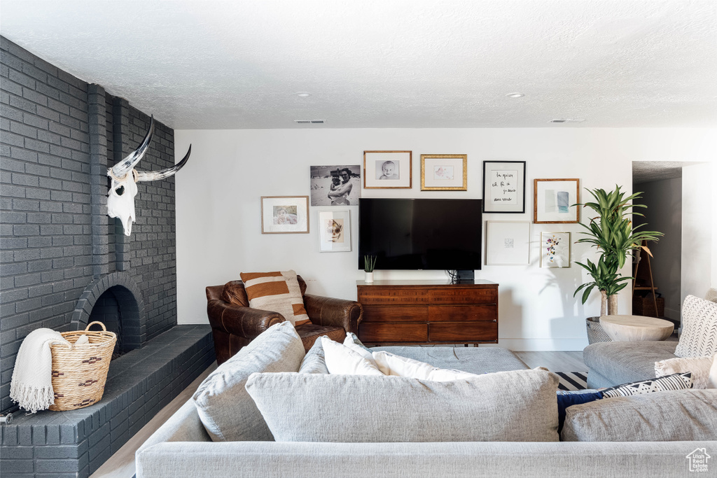 Living room featuring a textured ceiling and wood finished floors