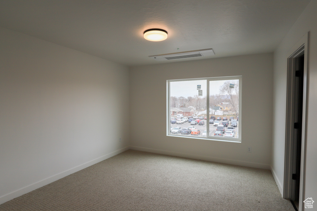 Empty room with carpet and baseboards