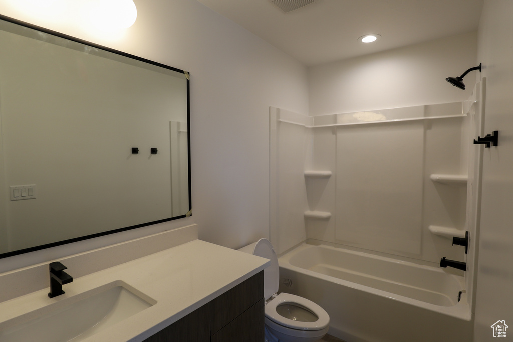 Bathroom with vanity, bathing tub / shower combination, toilet, and recessed lighting