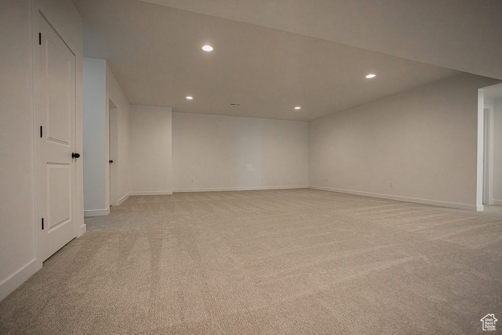 Spare room featuring recessed lighting, light carpet, and baseboards
