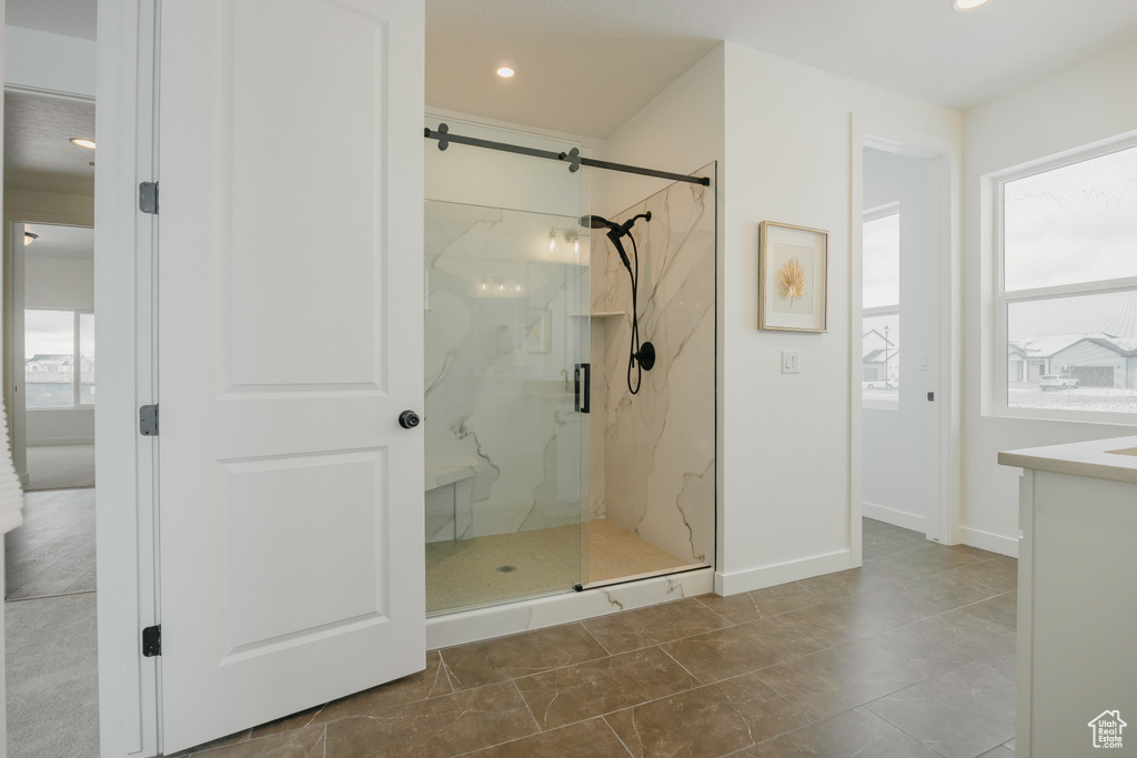 Bathroom featuring a marble finish shower, vanity, recessed lighting, and baseboards