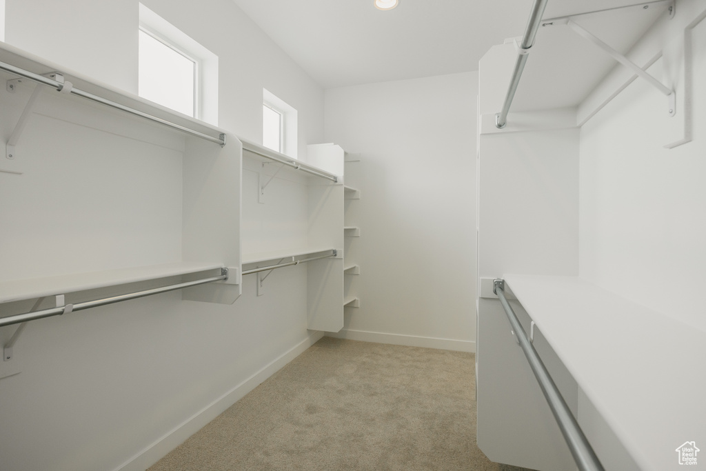 Spacious closet with light colored carpet