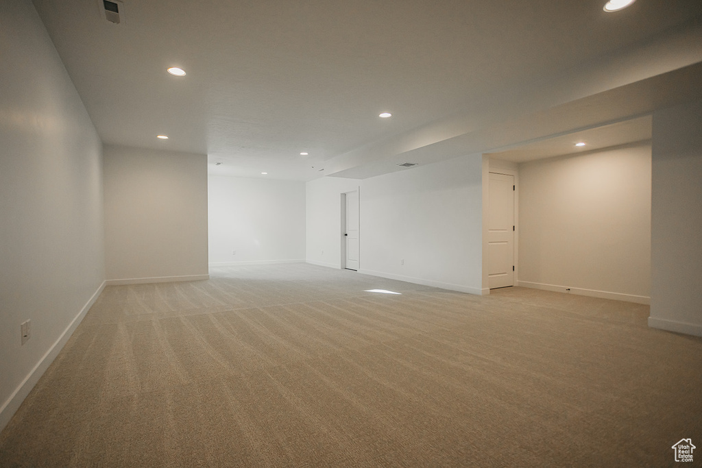 Below grade area featuring recessed lighting, light carpet, and baseboards