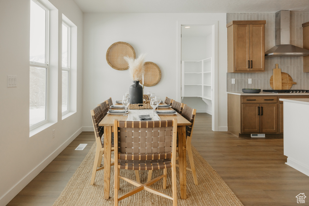 Dining area featuring wood finished floors and baseboards