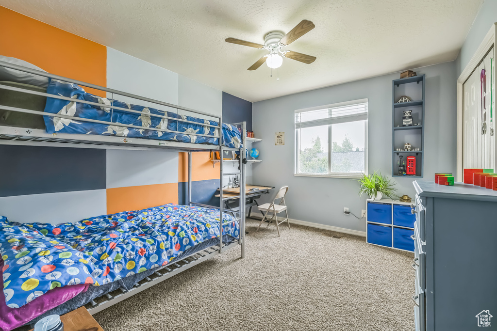 Bedroom featuring carpet, baseboards, and a ceiling fan