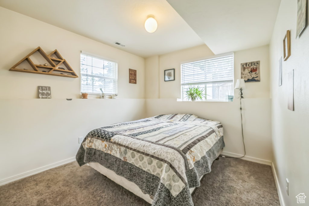 Bedroom featuring carpet flooring and baseboards